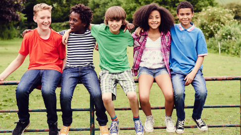 Young people sat on a gate