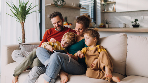 Family sitting together on the sofa