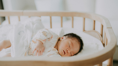 Newborn baby sleeping in a cot