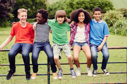 Young people sat on a gate