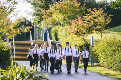 Group of secondary school age children walking together