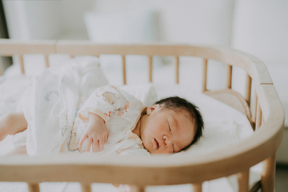 Newborn baby sleeping in a cot