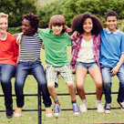 Young people sat on a gate