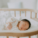 Newborn baby sleeping in a cot