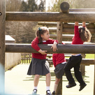 School children playing on outdoor climbing frame
