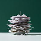Stack of papers with metal spike going through the pile