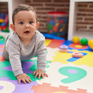Toddler crawling on play mat