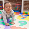 Toddler crawling on play mat