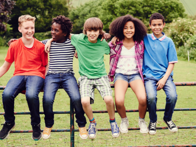 Young people sat on a gate