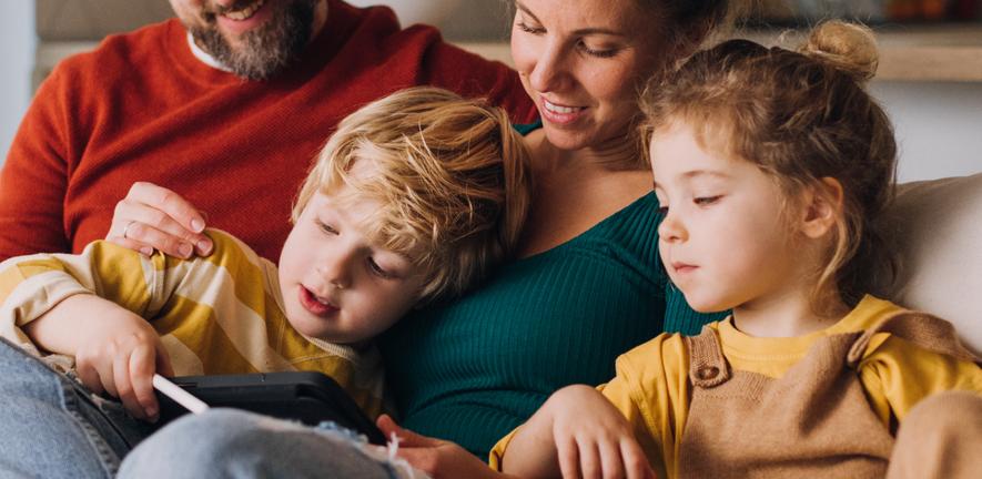 Family sitting together on the sofa
