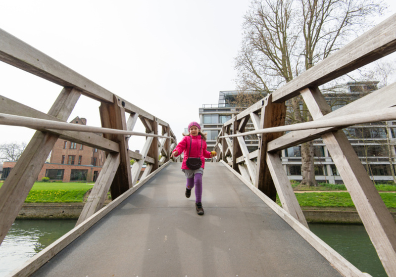 Child running across a bridge