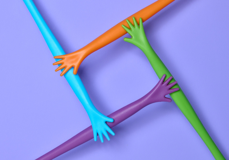 Multicoloured hands held in a square