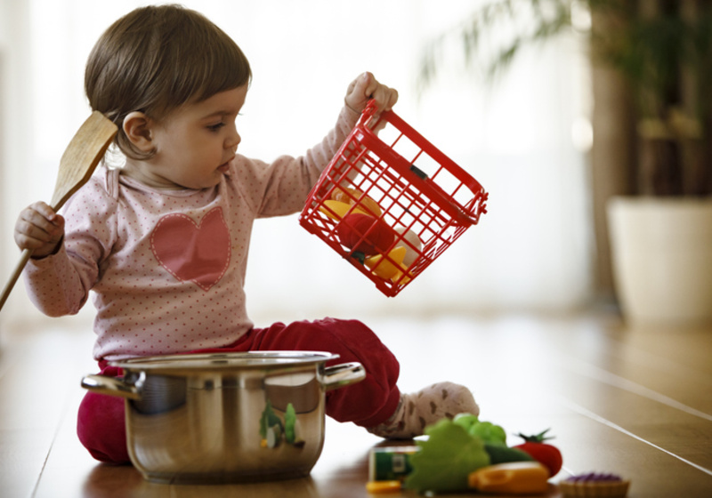 Young child playing with toy food